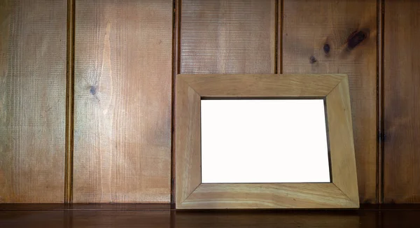 stock image Mock up of blank  wooden picture frame on wooden counter  against wood  background.