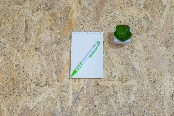 Notepad paper on wood background.