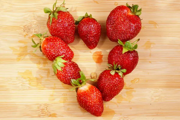 Dark red strawberry which is spread out in the form of heart — Stock Photo, Image