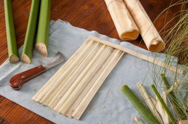 Strips obtained from the stem of papyrus plant with a typical knife and a finished rolled up sheets