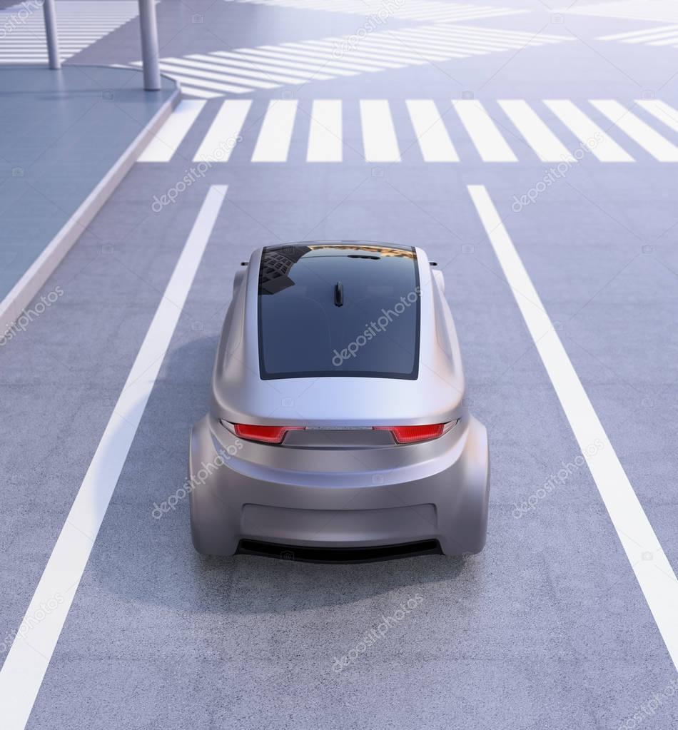 Rear view of autonomous vehicle waiting at intersection