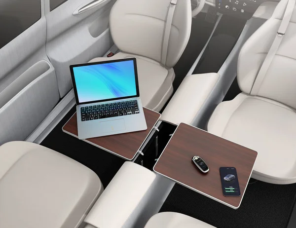Self driving car interior. Smart car key, smartphone, laptop on the table