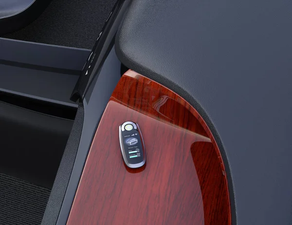 Smart car key on electric car\'s dashboard