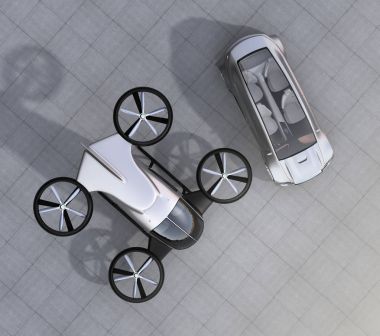 Top view of self-driving car and passenger drone parking on the ground clipart