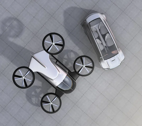 Top view of self-driving car and passenger drone parking on the ground — Stock Photo, Image