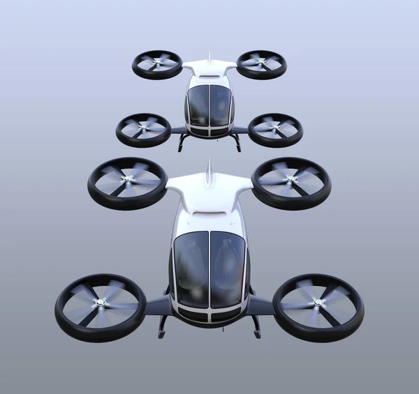 Front view of two self-driving passenger drones flying in the sky — Stock Photo, Image