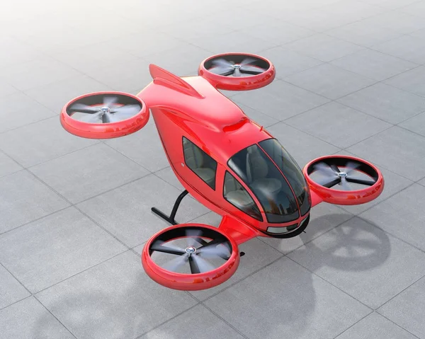 Red self-driving passenger drone landing on the ground — Stock Photo, Image