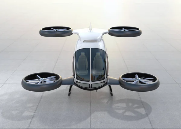 Vista frontal do drone de passageiro branco com direção automática pousando no chão — Fotografia de Stock