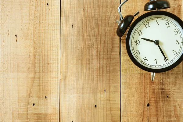 Retro alarm clock on wooden background. — Stock Photo, Image