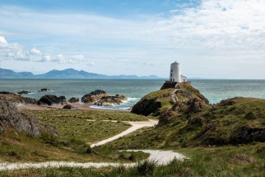 Tr Mawr lighthouse on Ynys Llanddwyn on Anglesey, Wales, marks the western entrance to the Menai Strait. clipart