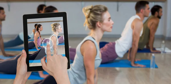 side view of people performing yoga