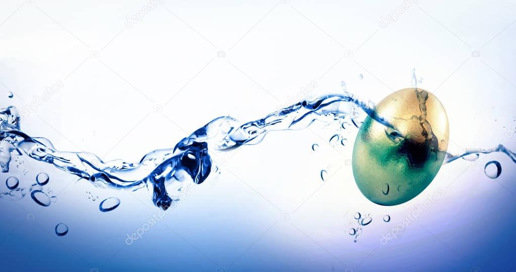 Golden Easter egg against water bubbling