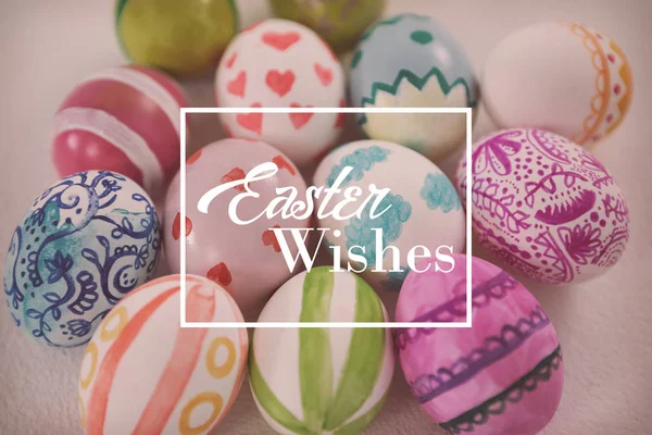 Easter greeting against painted easter eggs — Stock Photo, Image