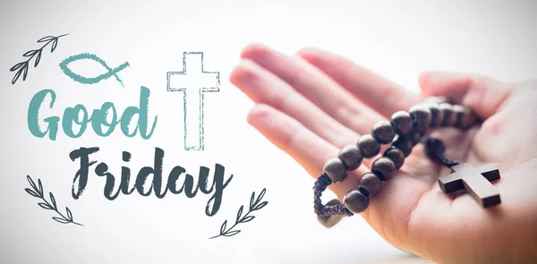 Hand holding rosary beads — Stock Photo, Image