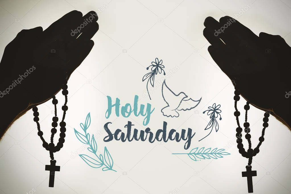 silhouette hand with rosary praying 