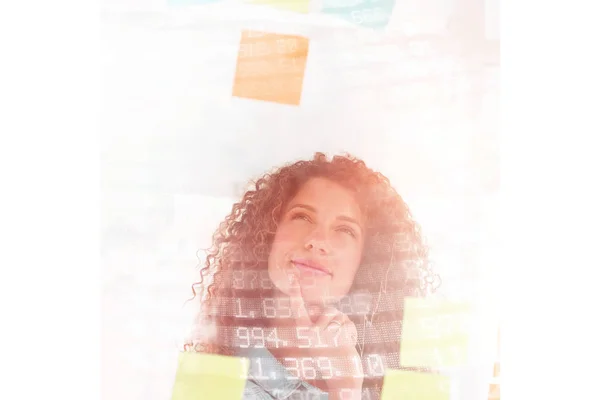 Female designer looking at sticky notes — Stock Photo, Image