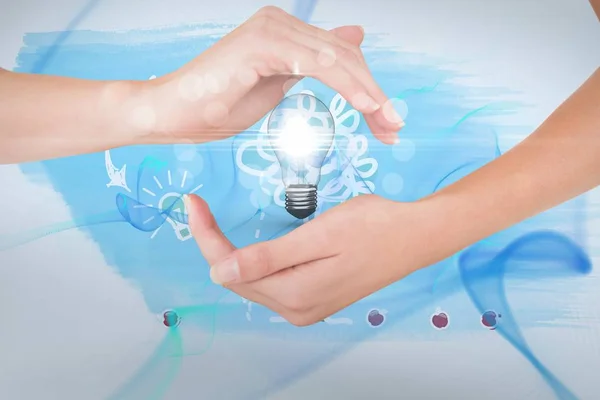 Digitally generated image of hand holding electric bulb — Stock Photo, Image