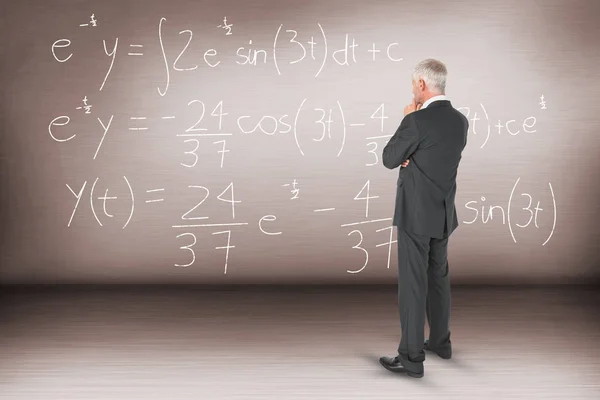 Thoughtful businessman standing back to camera — Stock Photo, Image