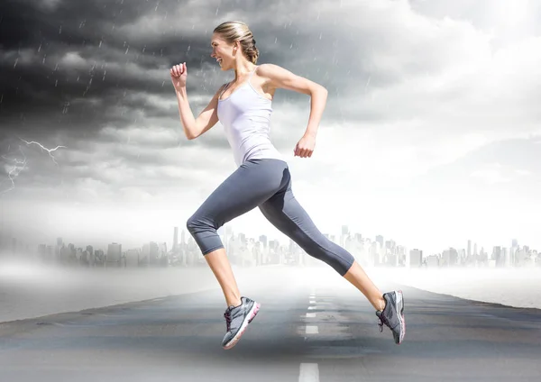 Runner going across road with skyline and storm — Stock Photo, Image