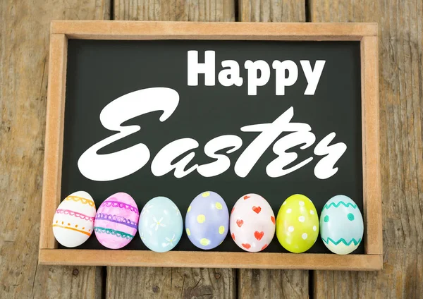 Type and easter eggs on chalkboard — Stock Photo, Image