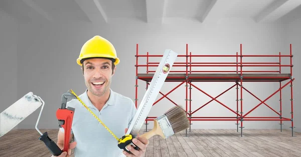 Builder with a lot of tools in font of 3D scaffolding — Stock Photo, Image