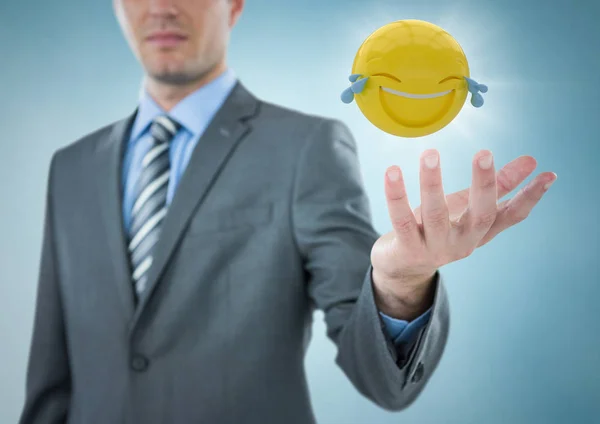 Uomo d'affari con mano fuori ed emoji con bagliore contro sfondo blu — Foto Stock