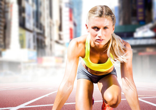 Woman runner on track in blurry city