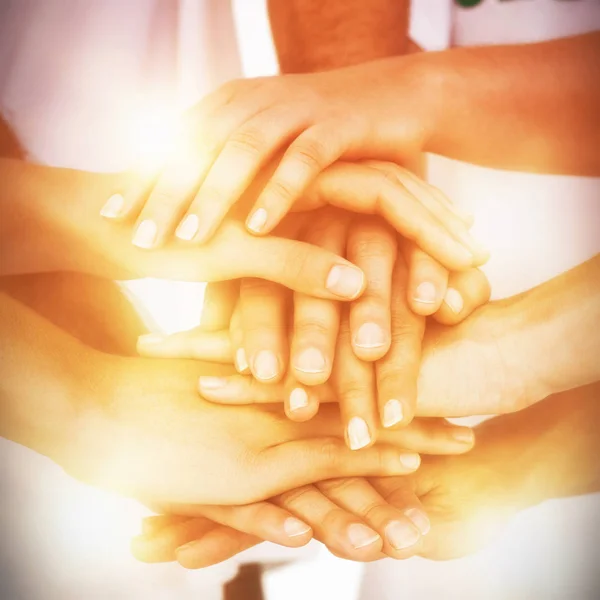 Mid section of volunteers putting hands together — Stock Photo, Image