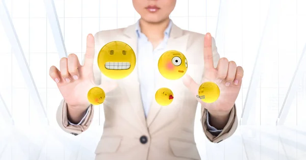 Mulher de negócios com emojis e flares entre mãos contra janela branca — Fotografia de Stock