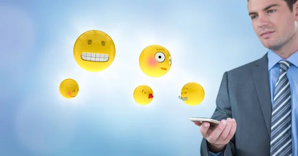 Uomo d'affari con telefono ed emoji con razzi sullo sfondo blu — Foto Stock