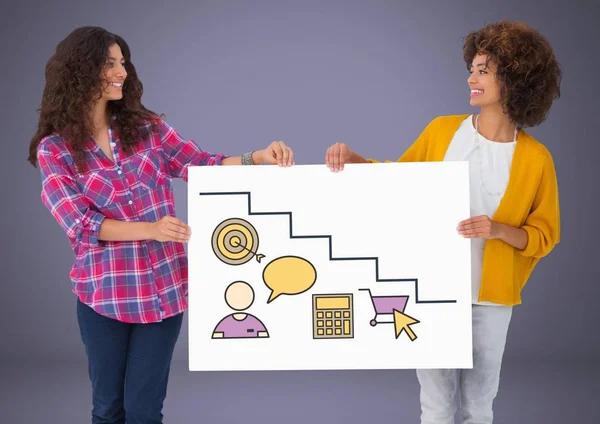 Two women holding card with targets