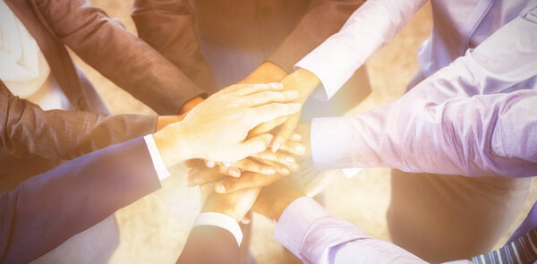 businesspeople stacking hands