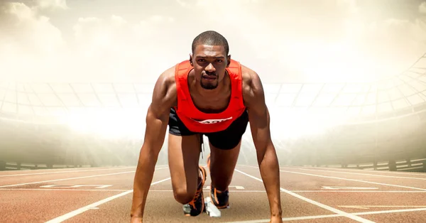 Male runner on track against flares — Stock Photo, Image