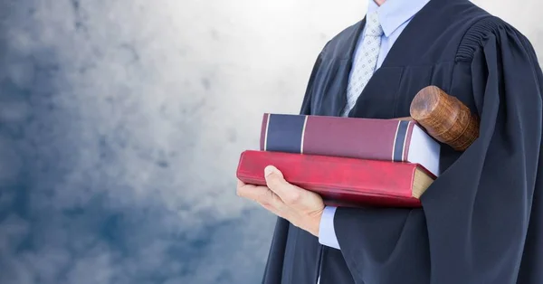 Judge holding book in front of sky clouds — Stock Photo, Image