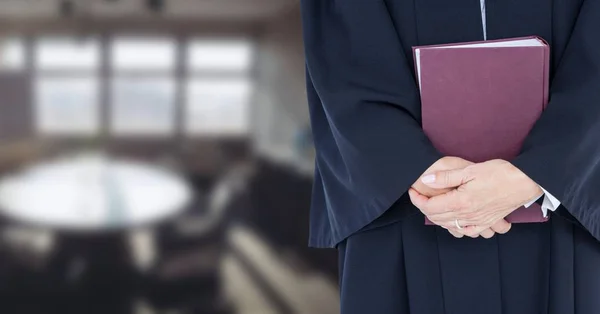 Judge holding book in front of office room — Stock Photo, Image