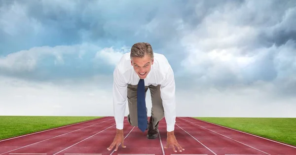 Businessman at starting position on tracks — Stock Photo, Image