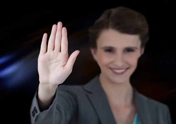 Woman waving with dark background — Stock Photo, Image