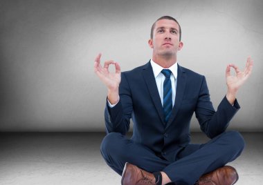 İş adamı gri odasında meditasyon parlama ile