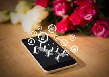 Masanın üzerine gül ile telefon