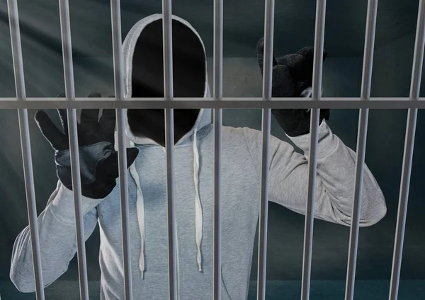 Penjahat tak dikenal berkerudung di balik jeruji penjara — Stok Foto