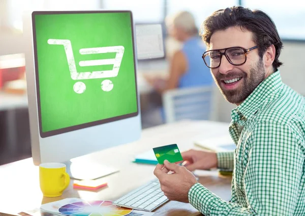 Man using computer with Shopping trolley — Stock Photo, Image