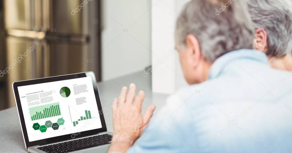 Senior business couple looking at laptop