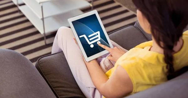 Woman touching shopping cart icon on tablet — Stock Photo, Image