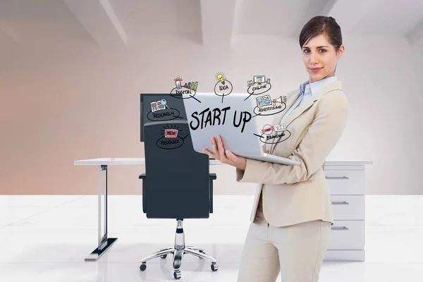 Businesswoman using laptop with start up — Stock Photo, Image