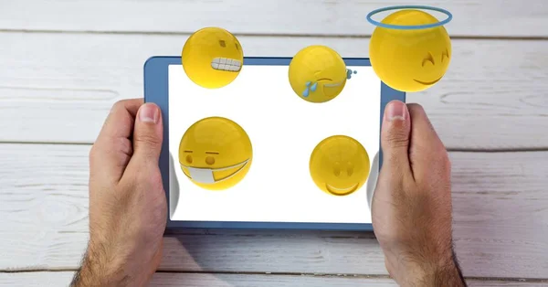 Emojis volando desde la tableta PC en poder del hombre — Foto de Stock