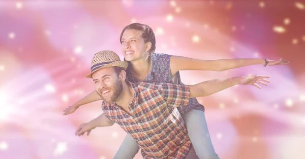 Man with with arms outstretched carrying woman — Stock Photo, Image