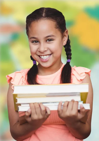 Girl with books against blurry map — Stock Photo, Image