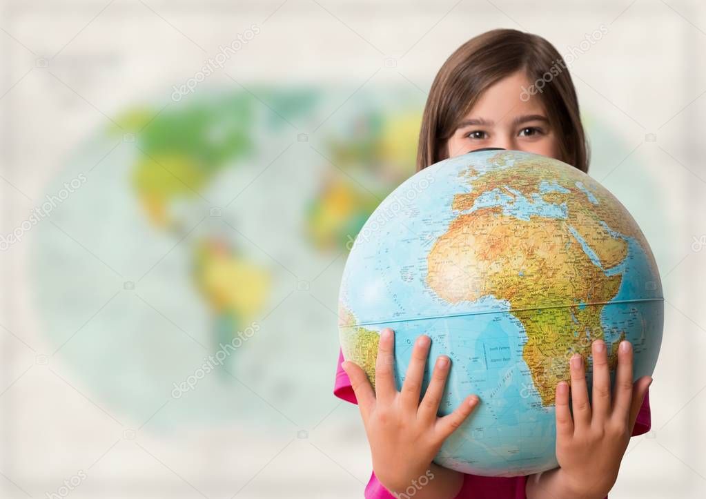 Girl with globe against blurry map