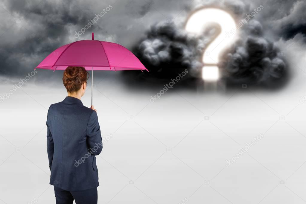 businesswoman with umbrella looking at question mark