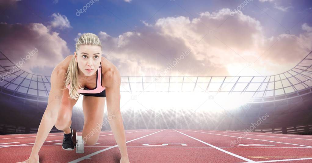 Sport runner at starting line in stadium